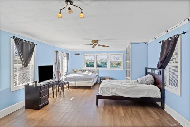 a bedroom with furniture window and flat screen tv