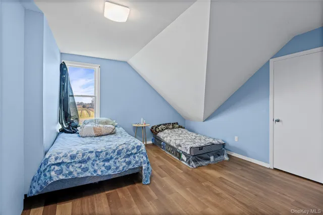 a bedroom with double bed and a window