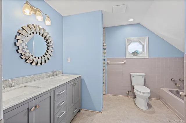 a bathroom with a toilet sink and mirror