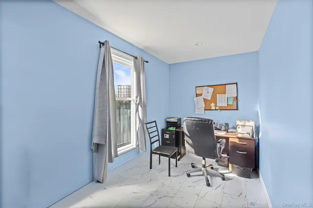 a work room with furniture and a window