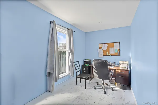 a work room with furniture and a window