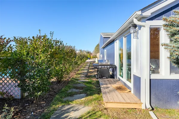 a view of a balcony with chairs and a potted plant