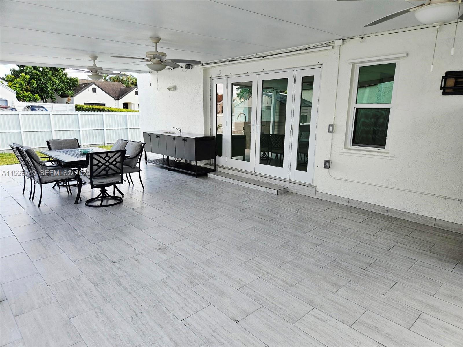 8041 Northwest 191st Street, Unit 8041 Hialeah, FL 33015 - Photo 11 of 11 a view of a patio with table and chairs