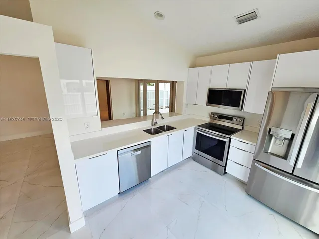 a kitchen with a refrigerator stove and a sink