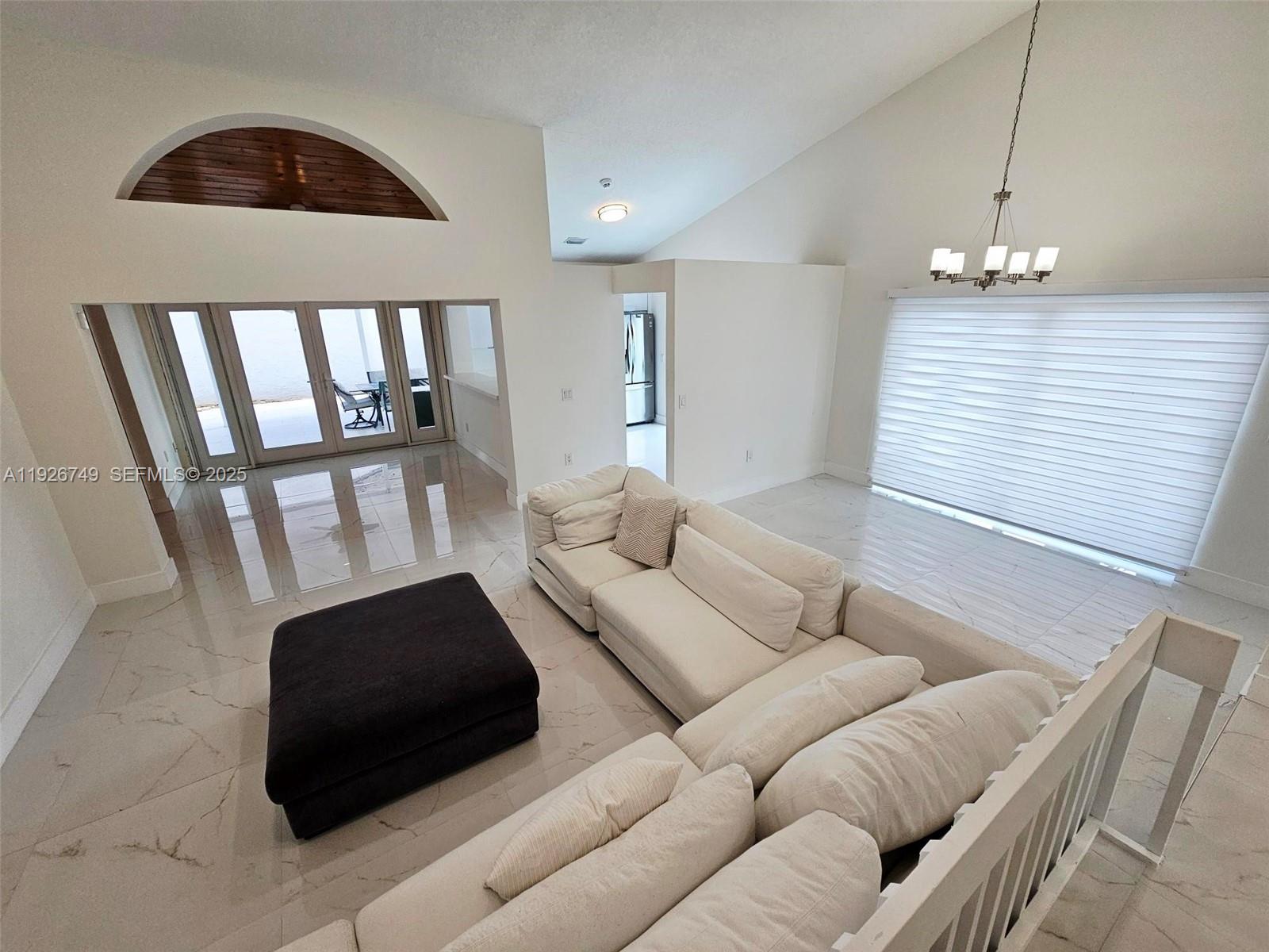 8041 Northwest 191st Street, Unit 8041 Hialeah, FL 33015 - Photo 3 of 11 a living room with furniture and a window