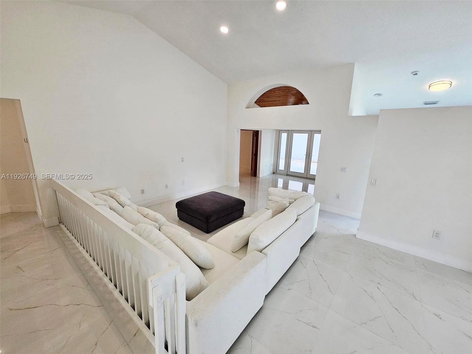 8041 Northwest 191st Street, Unit 8041 Hialeah, FL 33015 - Photo 7 of 11 a living room with a couch and a rug