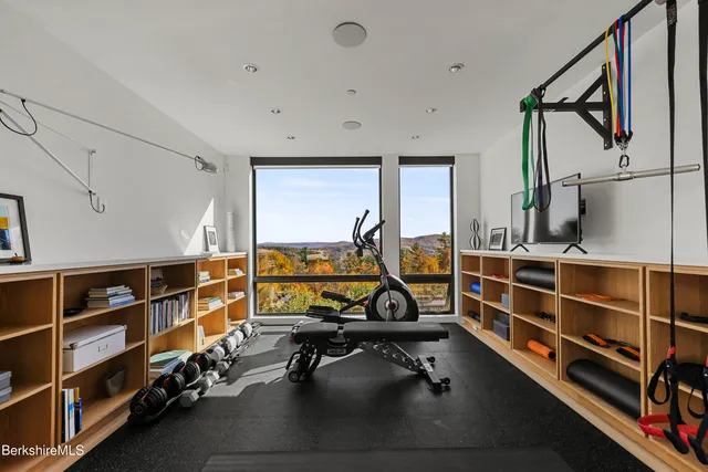 a bedroom with a bed and large window