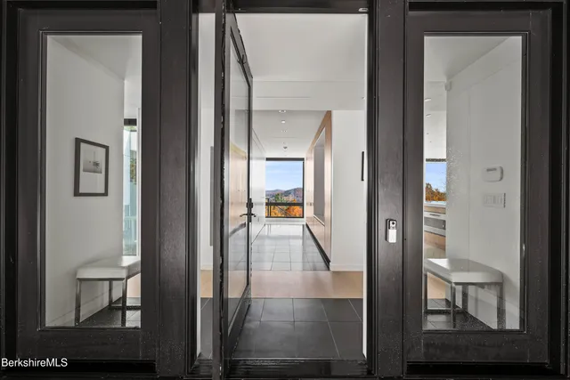 a living room with fireplace furniture and a floor to ceiling window