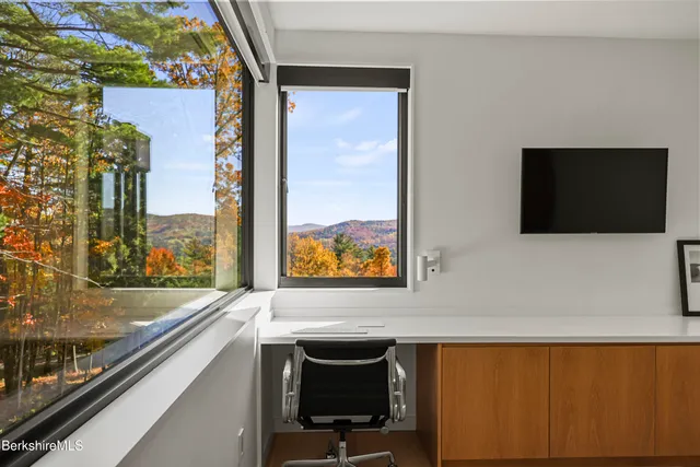 a view of a living room and balcony with furniture