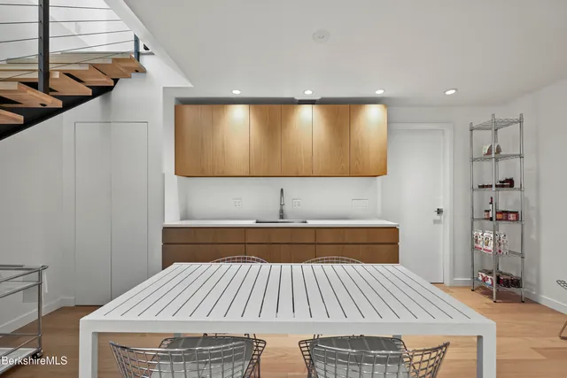 a view of a dining room with furniture large windows and wooden floor