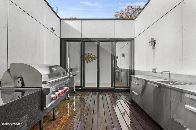 a hallway with wooden floor and windows