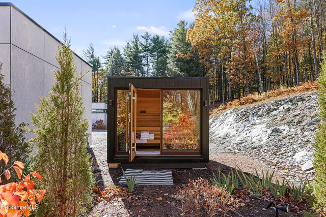 a view of a patio with couches and table and chairs with wooden fence
