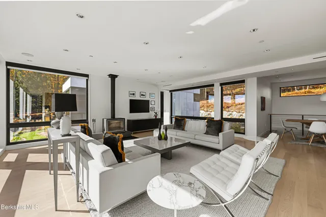 a kitchen with stainless steel appliances granite countertop a sink and a large window