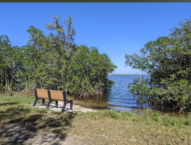a wooden bench sitting in the middle of a lake