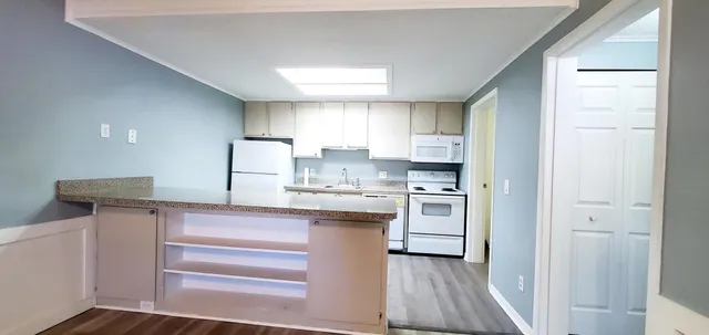 a kitchen with a refrigerator sink and cabinets