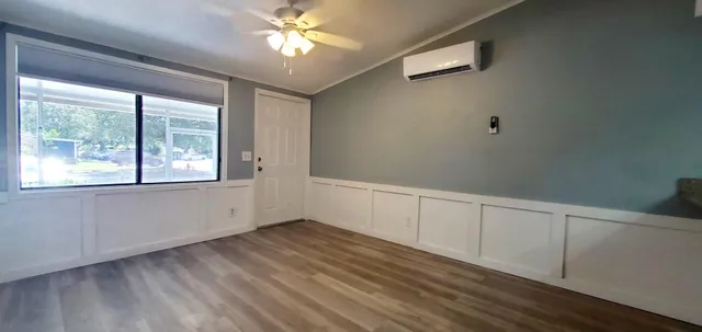a view of an empty room with a window and closet area