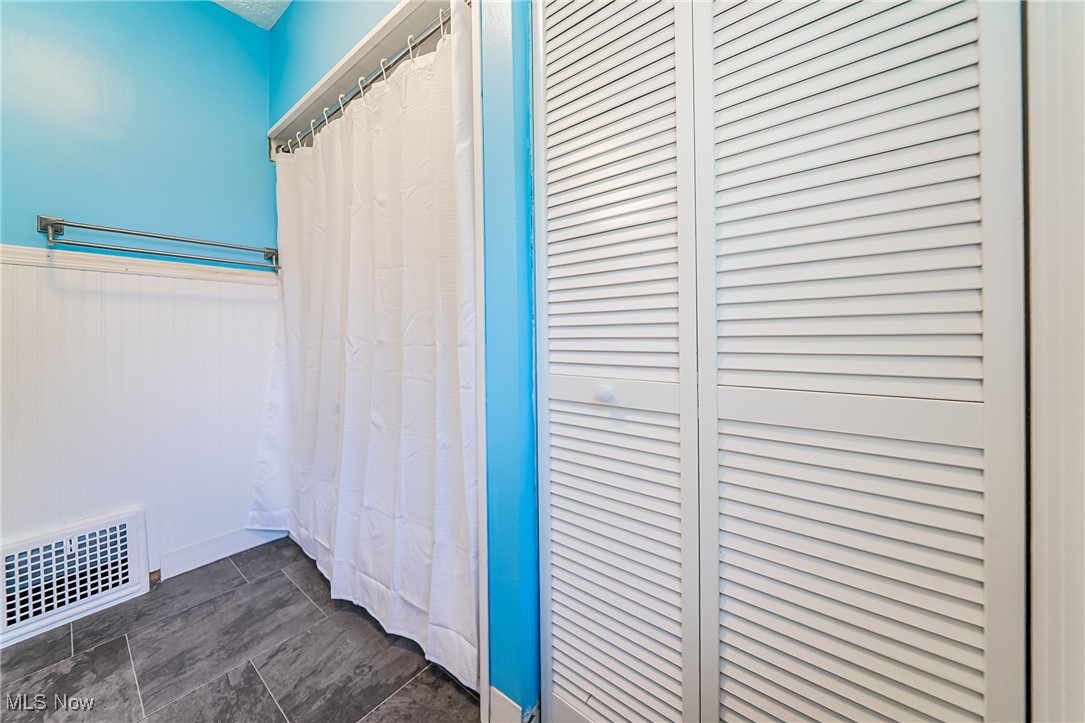 33384 Chestnut Ridge Road North Ridgeville, OH 44039 - Photo 16 of 30 Full bath with a closet, wainscoting, and a shower with shower curtain