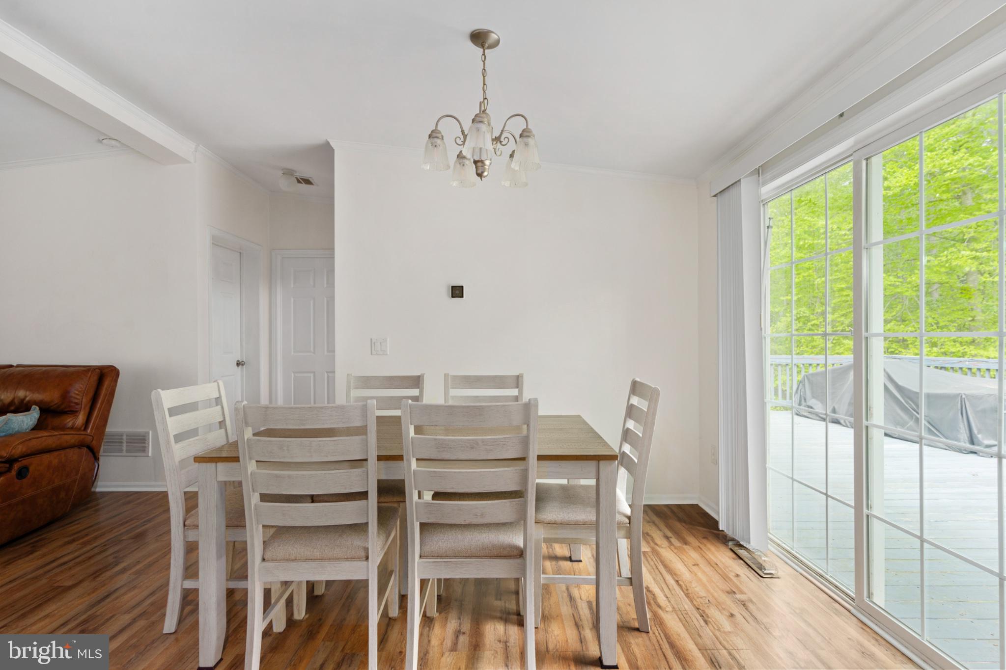 2319 Sizer Road Beaverdam, VA 23015 - Photo 26 of 61 a view of a dining room with furniture window and wooden floor