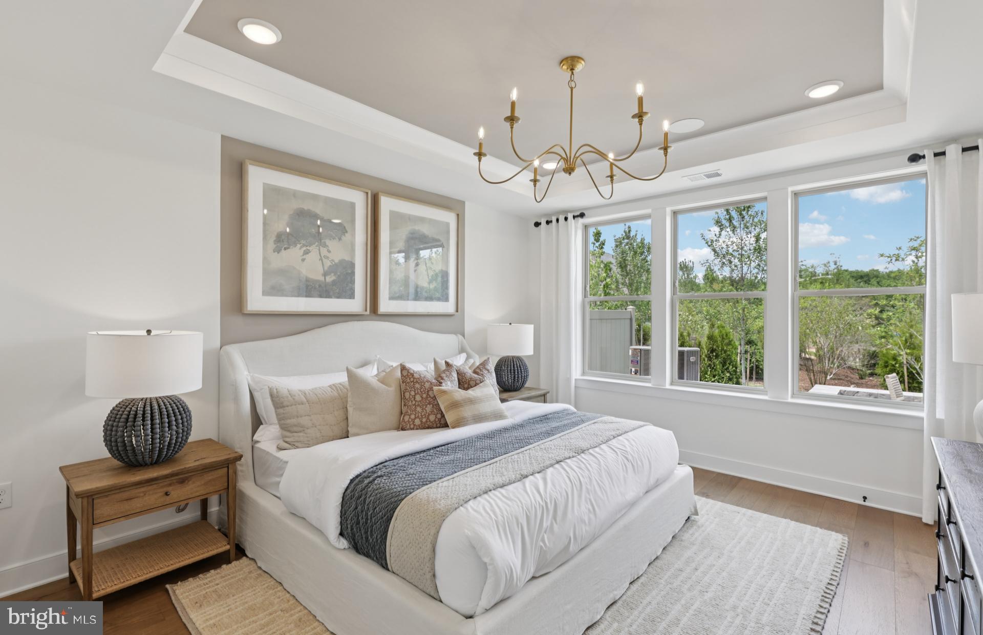 6152 Amber Lane, Unit 2 Haymarket, VA 20169 - Photo 12 of 57 a bedroom with a large bed and a chandelier