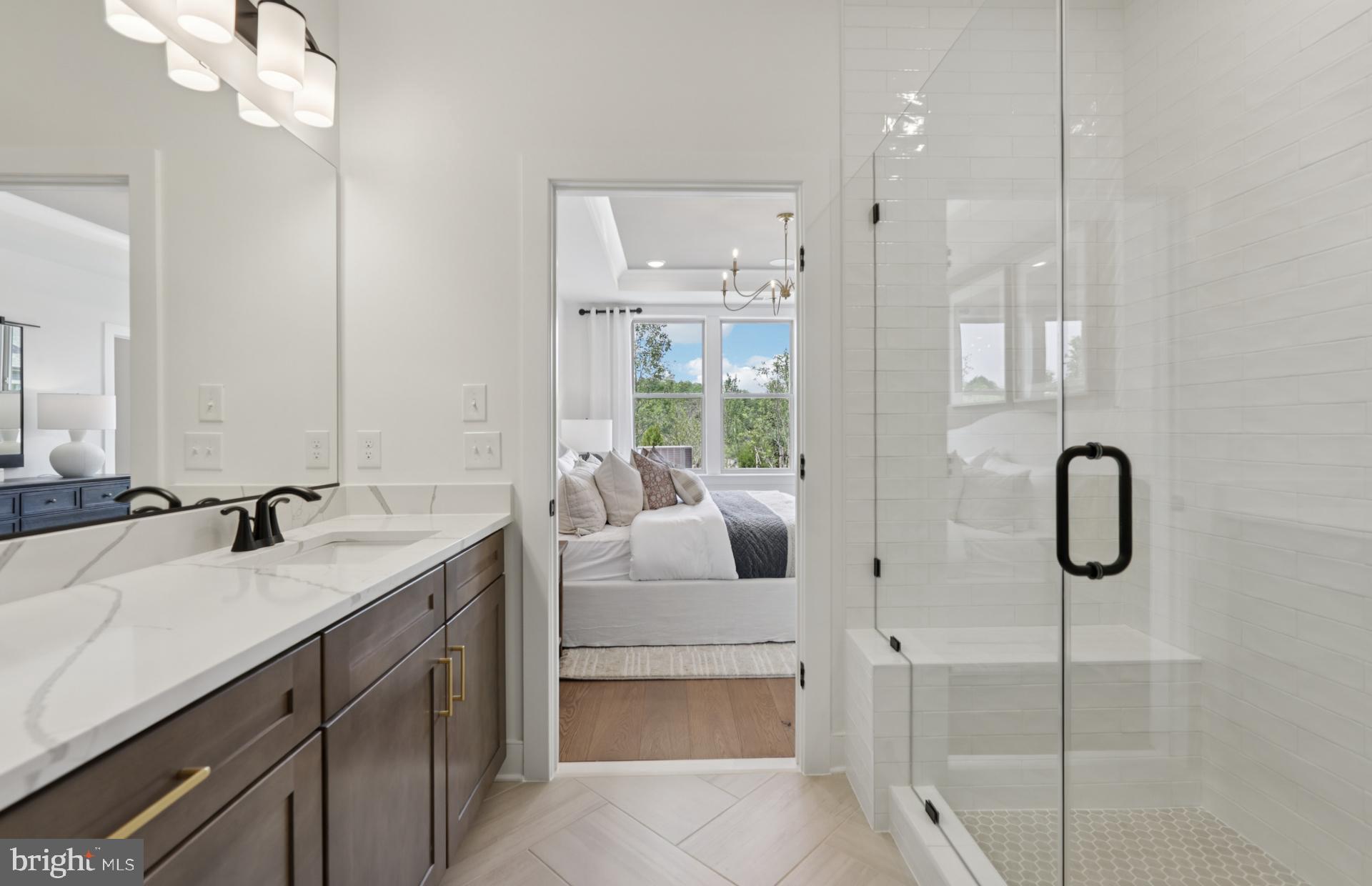 6152 Amber Lane, Unit 2 Haymarket, VA 20169 - Photo 18 of 57 a bathroom with a double vanity sink a mirror and a shower