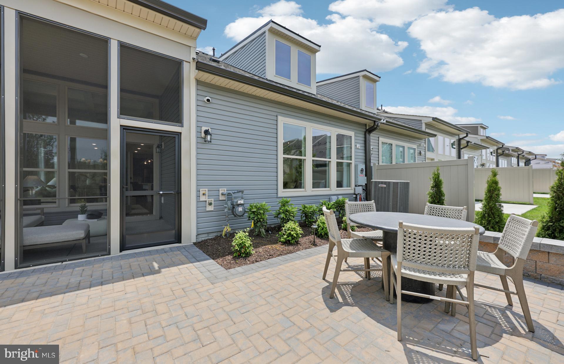 6152 Amber Lane, Unit 2 Haymarket, VA 20169 - Photo 20 of 57 a patio with a table and chairs and potted plants