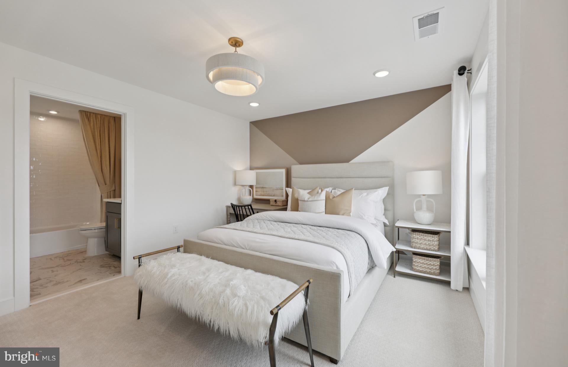 6152 Amber Lane, Unit 2 Haymarket, VA 20169 - Photo 30 of 57 a bedroom with a bed and a chandelier