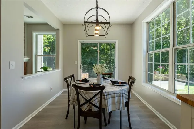 a dining room with a window and a chandelier