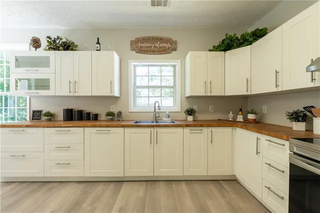 a kitchen with granite countertop white cabinets and white appliances