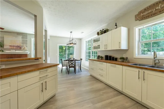 a large white kitchen with white cabinets and a dishwasher