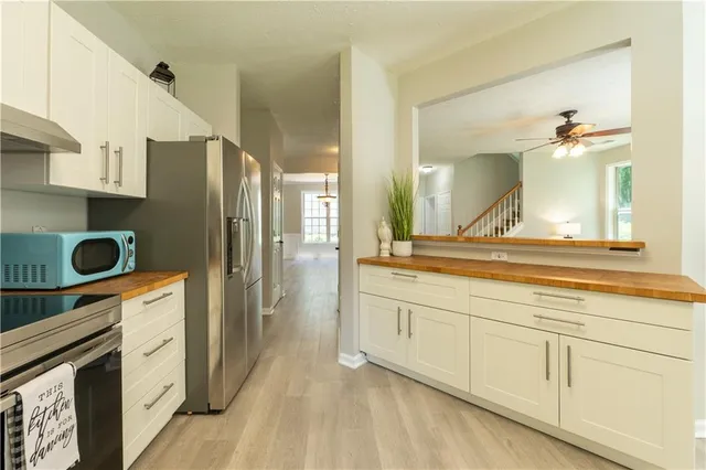 a spacious bathroom with a granite countertop double vanity sink and a mirror