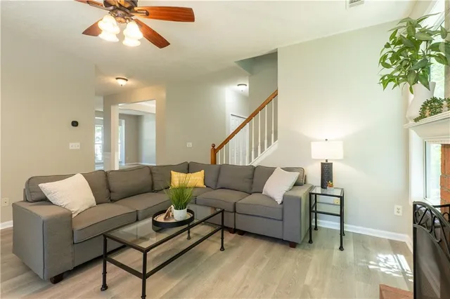 a living room with furniture and a potted plant