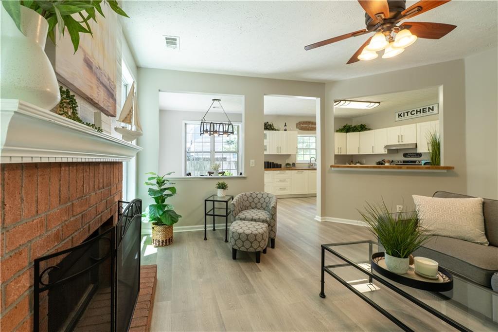 2238 St Albans Place Buford, GA 30519 - Photo 22 of 56 a living room with furniture and a fireplace