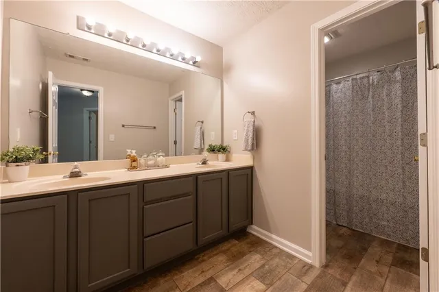 a bathroom with a double vanity sink and a mirror