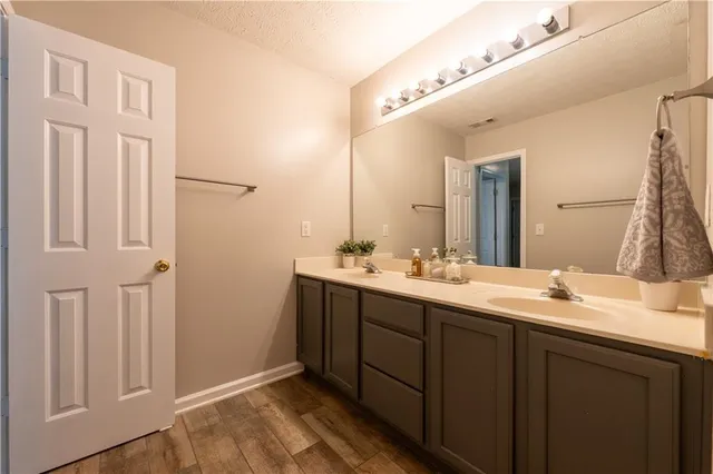 a bathroom with a double vanity sink and a mirror