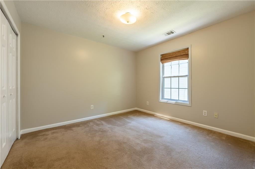 2238 St Albans Place Buford, GA 30519 - Photo 28 of 56 an empty room with a empty space and a window