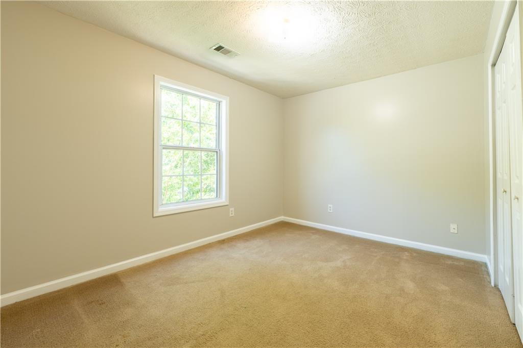 2238 St Albans Place Buford, GA 30519 - Photo 31 of 56 an empty room with a window