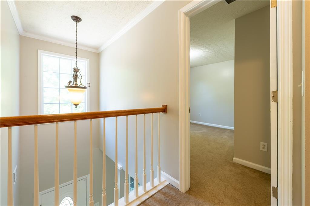 2238 St Albans Place Buford, GA 30519 - Photo 32 of 56 a view of a hallway with windows
