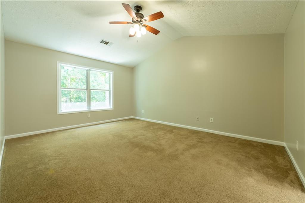 2238 St Albans Place Buford, GA 30519 - Photo 34 of 56 an empty room with a window and a fan