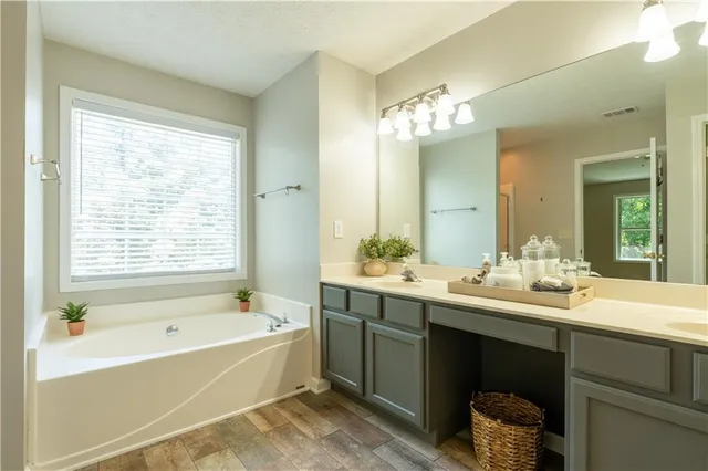 a spacious bathroom with a double vanity sink and a mirror