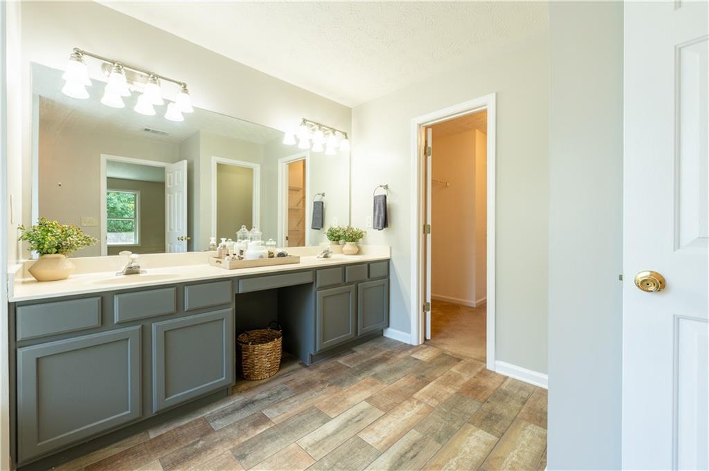 2238 St Albans Place Buford, GA 30519 - Photo 39 of 56 a spacious bathroom with a double vanity sink and a mirror