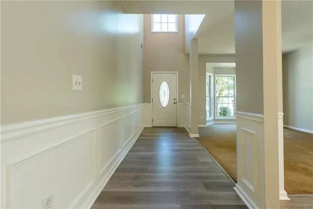a view of a hallway with wooden floor and staircase