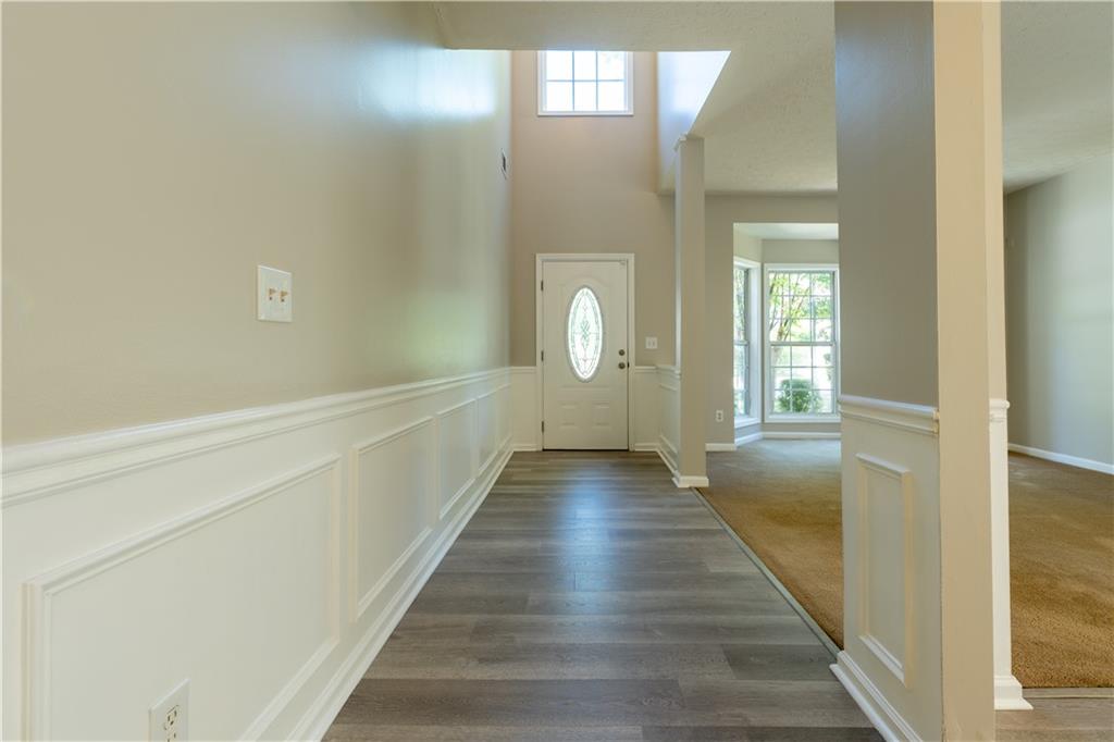2238 St Albans Place Buford, GA 30519 - Photo 5 of 56 a view of a hallway with wooden floor and staircase