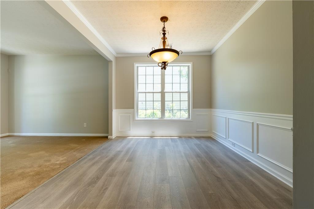 2238 St Albans Place Buford, GA 30519 - Photo 6 of 56 wooden floor in an empty room with a window