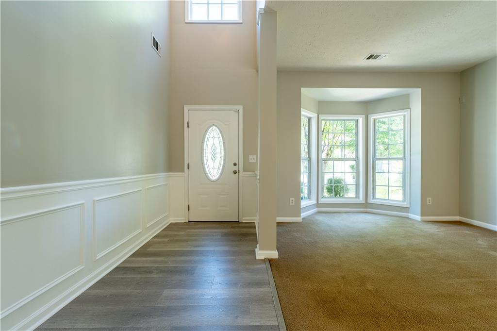 2238 St Albans Place Buford, GA 30519 - Photo 7 of 56 an empty room with wooden floor and windows