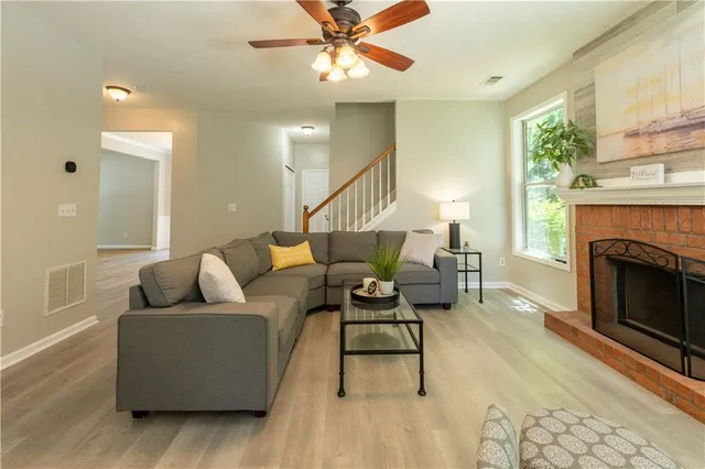 a living room with furniture and a fireplace