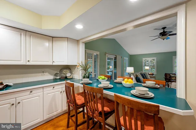 a bedroom with a large bed a chandelier and windows
