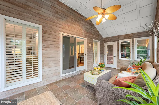 a bedroom with a bed table and a window