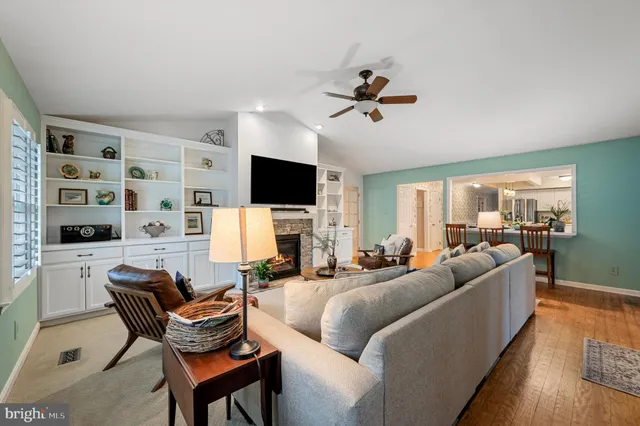 a living room with furniture and white kitchen