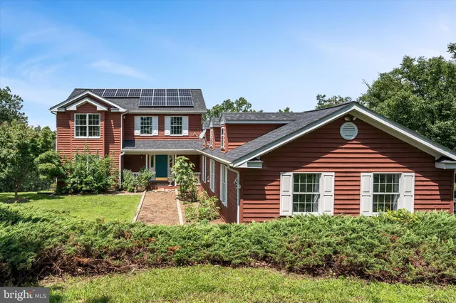 a view of a porch with furniture and garden