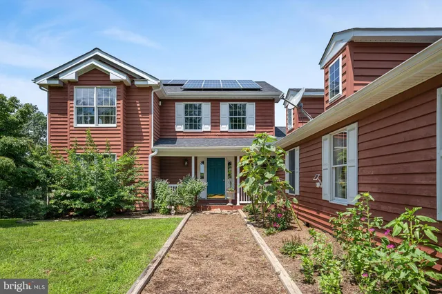 a view of a house with a yard and plants